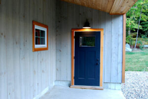 Geobarns, Mountain Carriage House, exterior entry porch, blue door