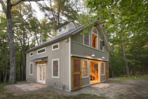 GeoBarns, Massachusetts Woodworking Barn, exterior entry barn doors, windows, hayloft door, wooded site