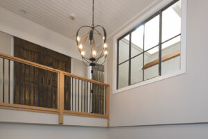 GeoBarns, mountaintop New Hampshire home, light fixture, entry, daylight, railing detail