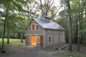 Geobarns, Massachusetts Woodworking Barn, exterior entry barn doors, windows, hayloft door, wooded site