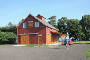 Geobarns, Lake Erie Auto Barn, exterior entry, porch, sliding barn doors, red barn
