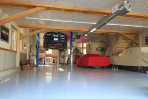 GeoBarns, Hudson Valley Auto Barn interior lift, finished ceiling, timber frame clear span