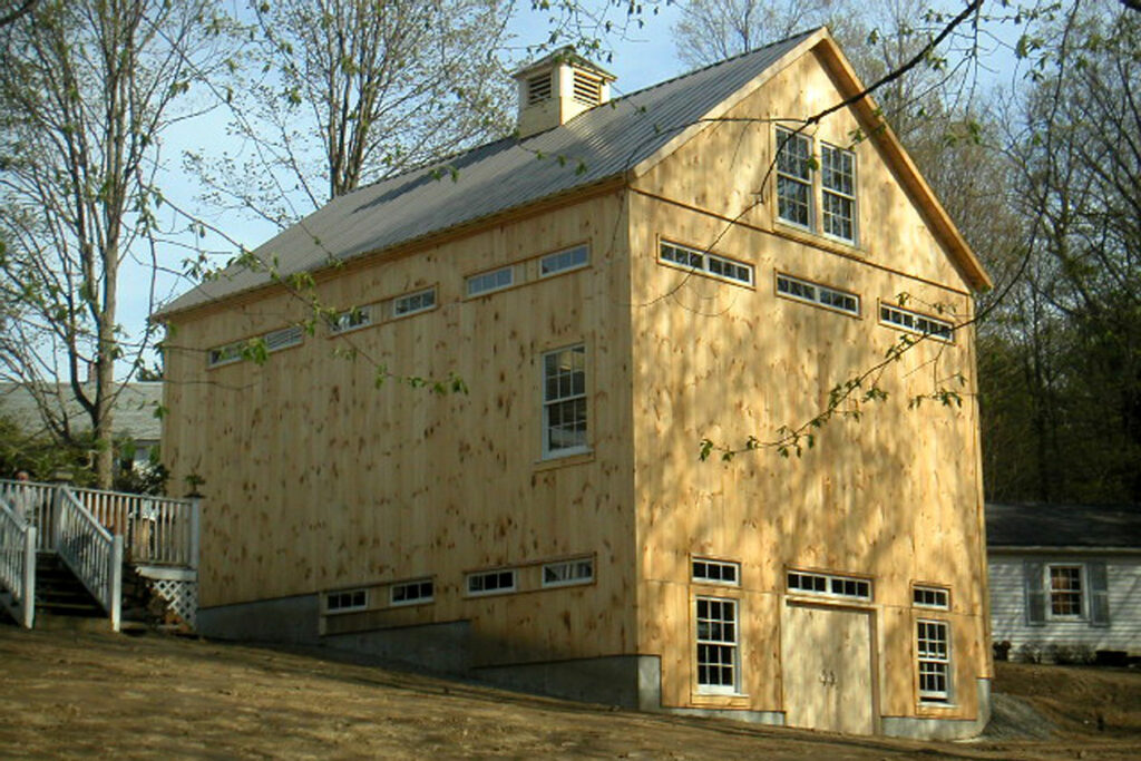 An exterior picture of Bruce Blanchette's art studio, design and built by Geobarns, showing how a bank barn provides ground access to two different levels.