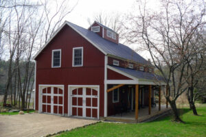 garage apartment, exterior, red barn, garage doors, cupola, porch, timber, patio, barn doors