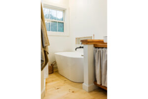 Geobarns, Shenandoah Modern Farmhouse bathroom with white soaking bathtub