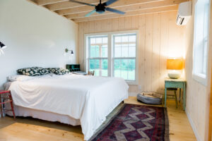 Geobarns, Shenandoah Modern Farmhouse bedroom with natural wood paneling