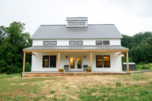Geobarns, Shenandoah Modern Farmhouse Exterior with white siding, metal roof, and front porch
