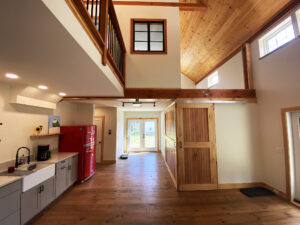 Geobarns; VT; Recreation Barn; Green Siding; Rolling Barn Doors; Cupola; Entertainment Room; Open Interior; Vaulted Ceiling; Home Office