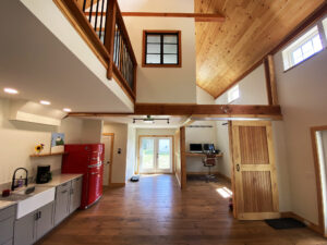 Geobarns; VT; Recreation Barn; Green Siding; Rolling Barn Doors; Cupola; Entertainment Room; Open Interior; Vaulted Ceiling; Home Office