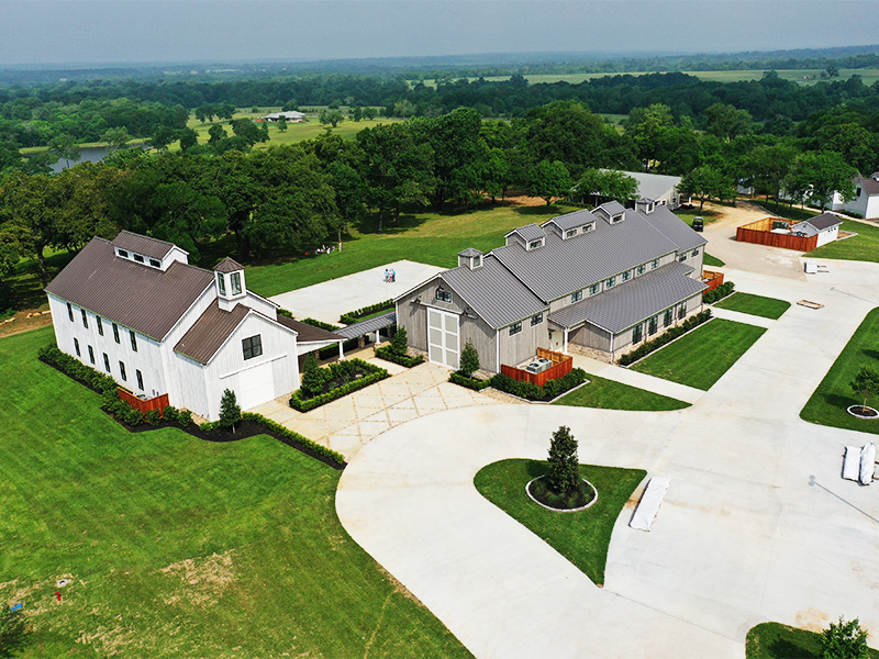 An aerial picture of Arrowed Hill Wedding and Events venue in Texas, showing a chapel and a reception hall, designed and built by Geobarns.