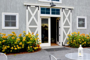 A picture of the entrance to a Wedding Barn in Vermont with rolling barn door shutters