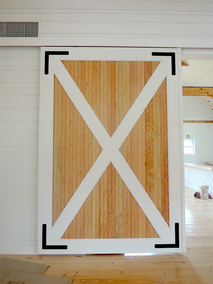 A picture of a rolling barn door interior partition design and built by Geobarns for the Barn at Smuggler's Notch in Vermont